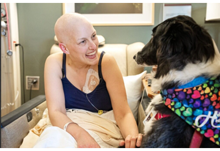 Patient receiving a visit from a therapy dog